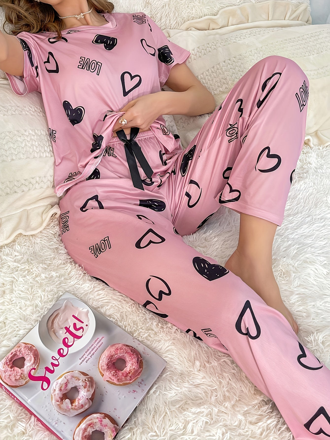 An adorable pink heart and letter print Women's pajama set, featuring a short-sleeve round-neck top paired with long pants, soft and comfortable